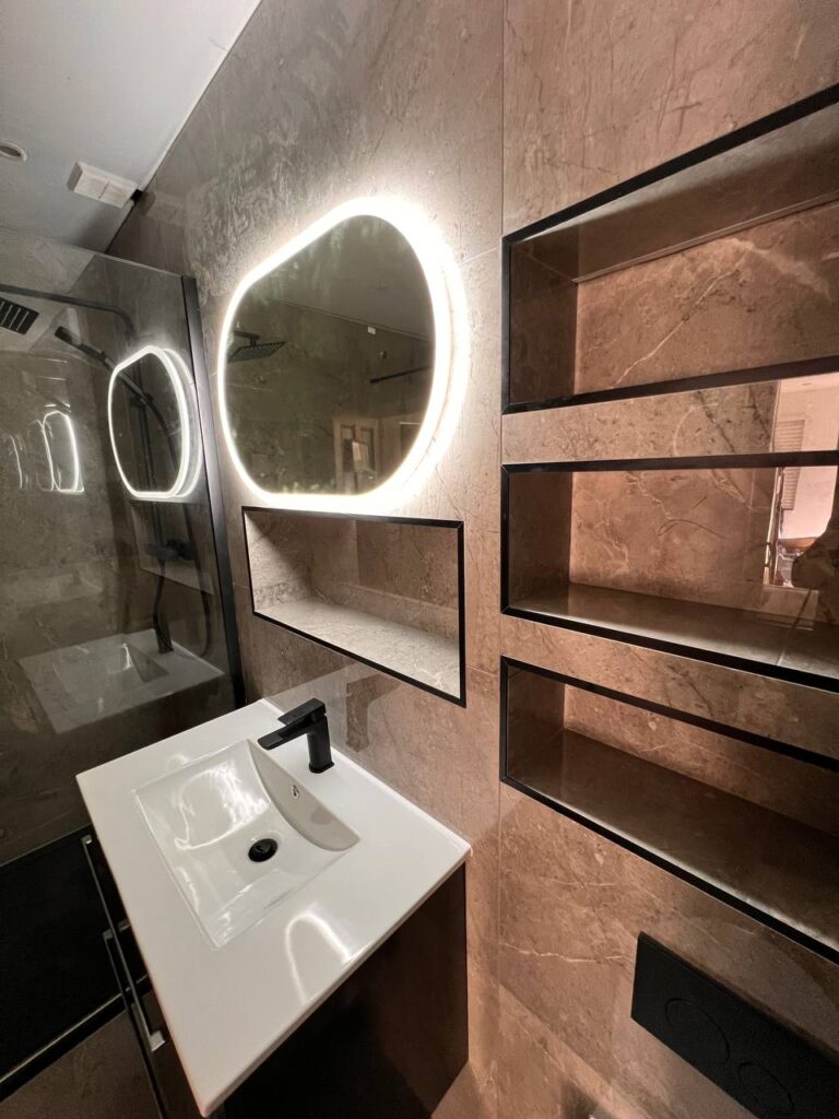 An image showing a bathroom sink below the mirror